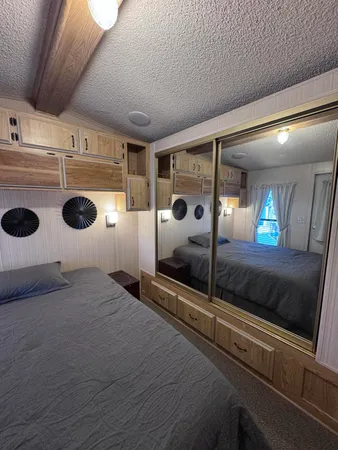 a bedroom with a bed and a mirror