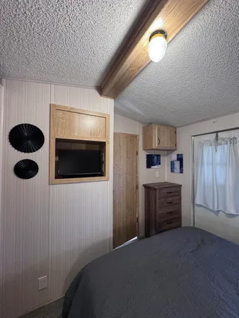 a bedroom with a bed and a television