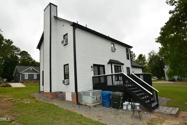 a front view of house with deck and yard