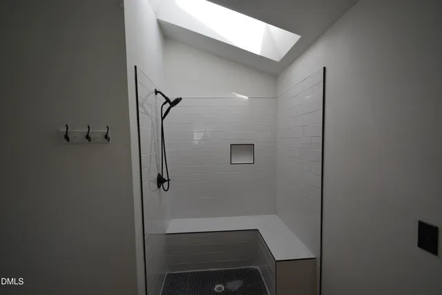 a bathroom with a glass shower door