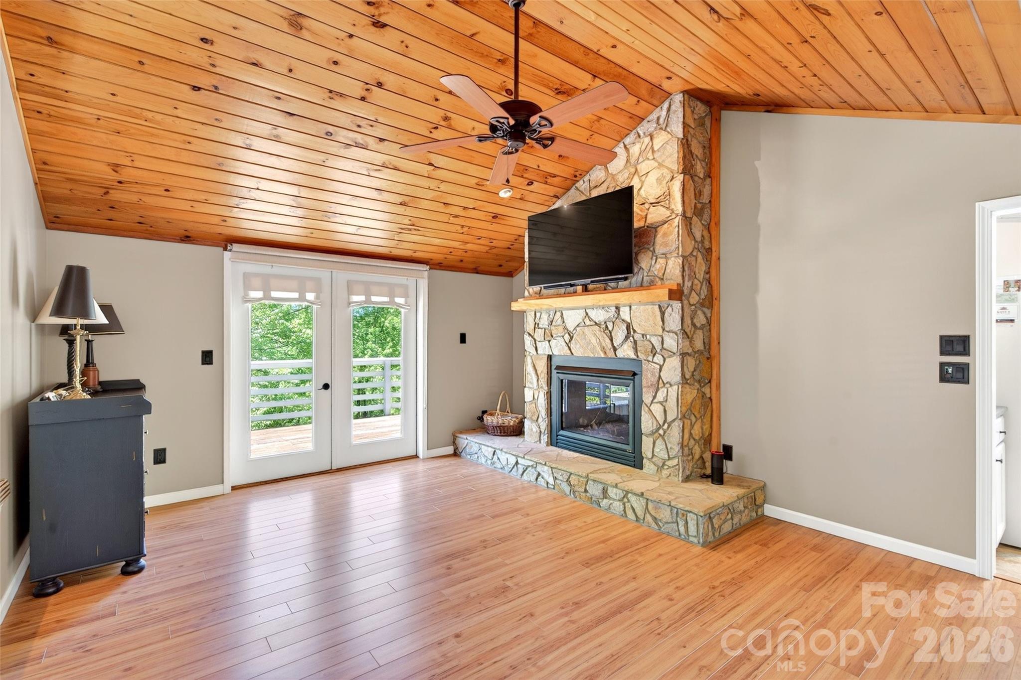 334 Harbor Lake Road Newland, NC 28657 - Photo 10 of 48 a view of a livingroom with a fireplace window and wooden floor