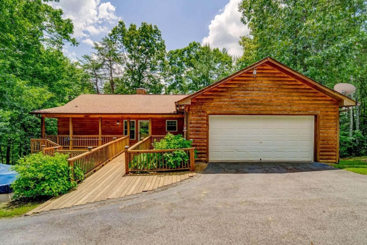 349 Squirrel Hunting Road Ellijay, GA 30536 - Photo 1 of 1 a front view of a house with a garden