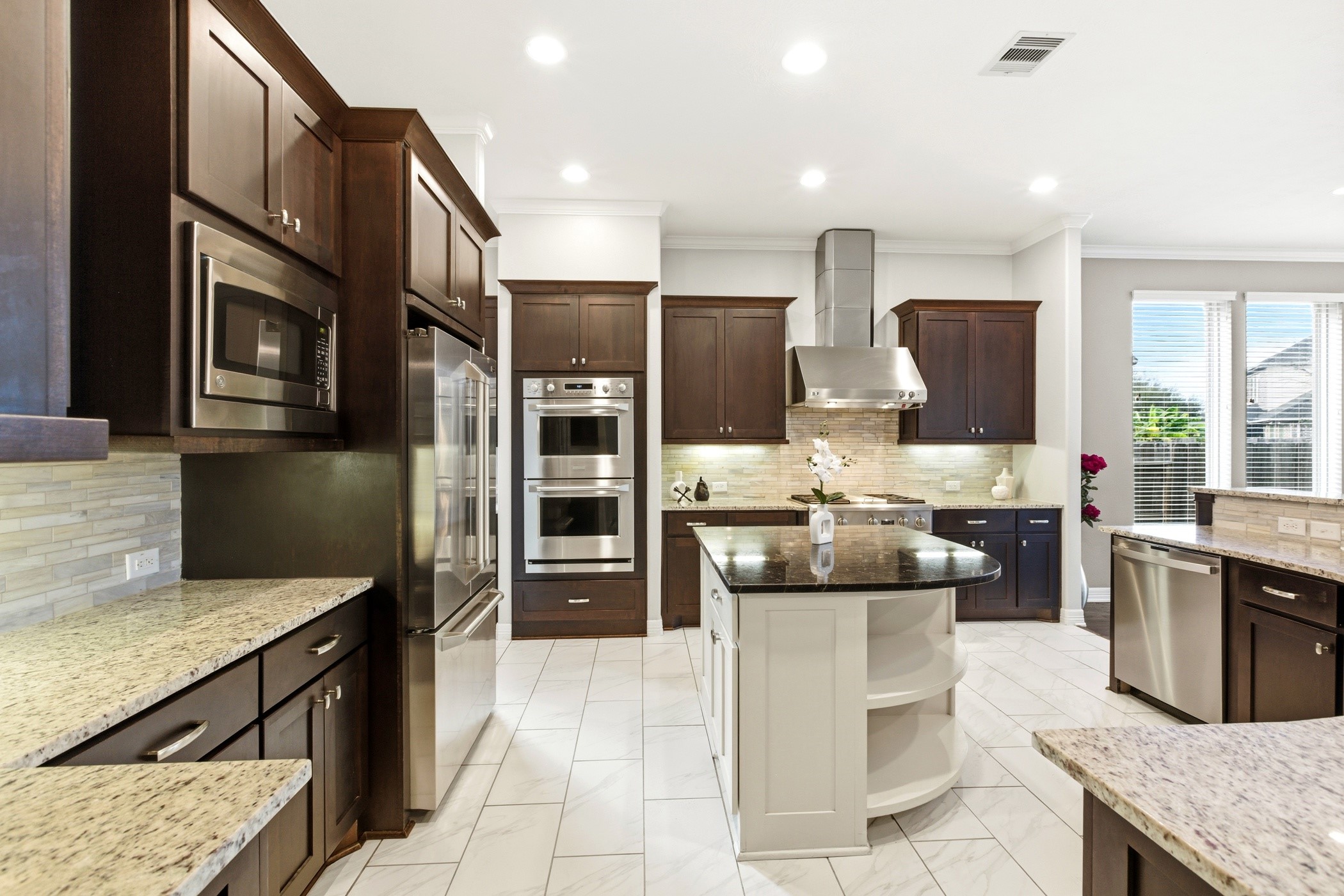 27834 Hunters Rock Lane Katy, TX 77494 - Photo 21 of 46 a kitchen with stainless steel appliances kitchen island granite countertop a refrigerator and stove