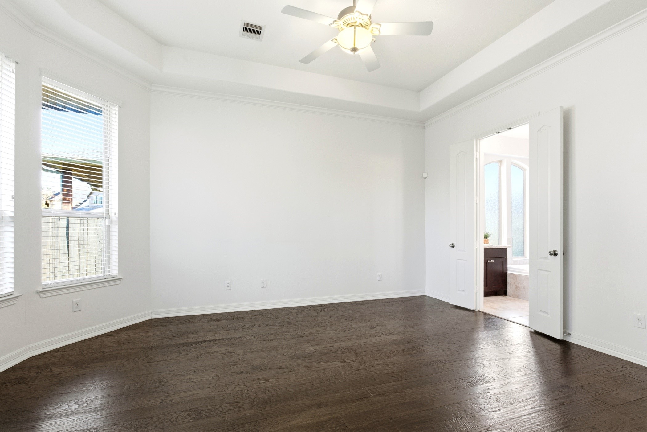 27834 Hunters Rock Lane Katy, TX 77494 - Photo 28 of 46 an empty room with wooden floor and windows