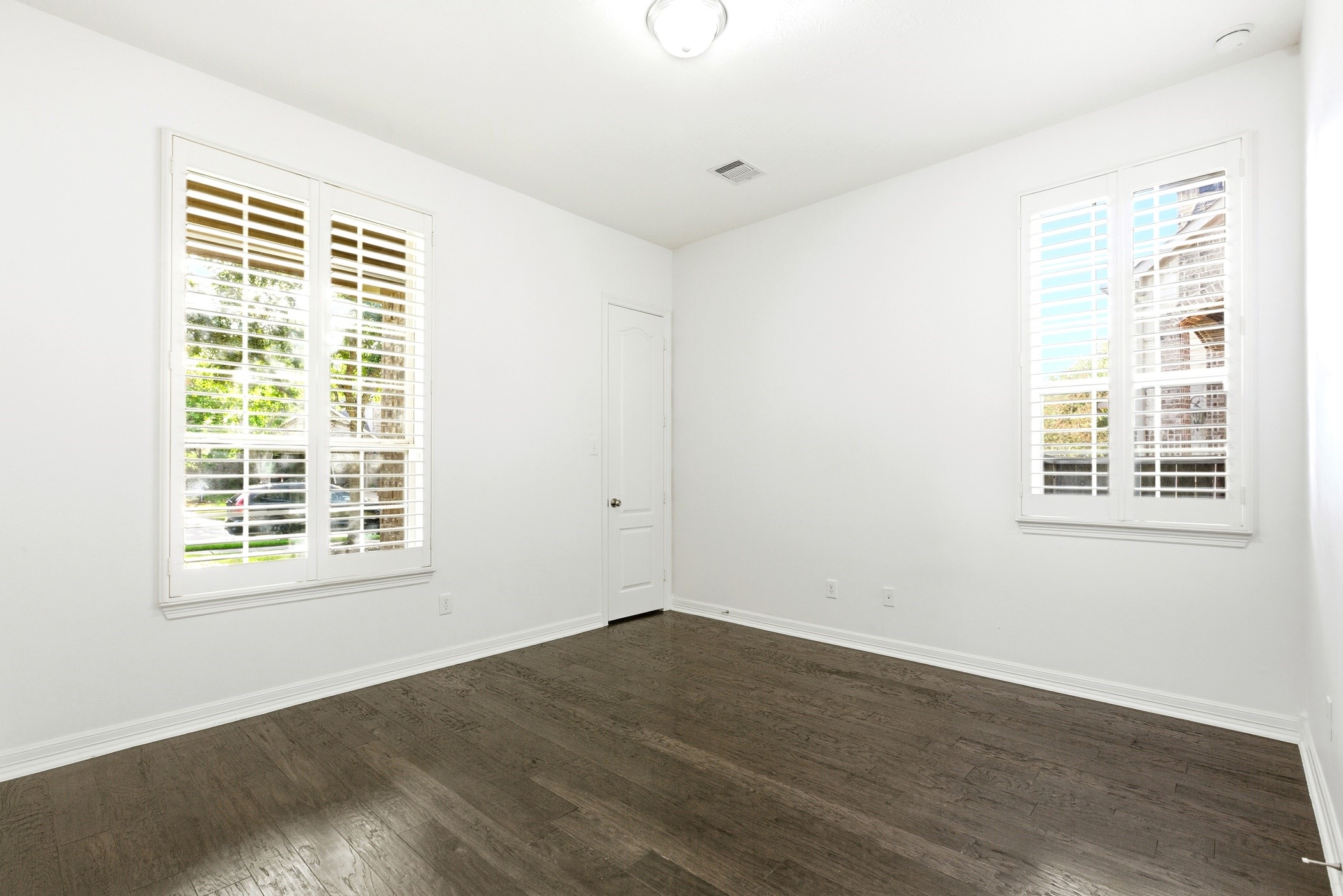 27834 Hunters Rock Lane Katy, TX 77494 - Photo 36 of 46 an empty room with wooden floor and windows