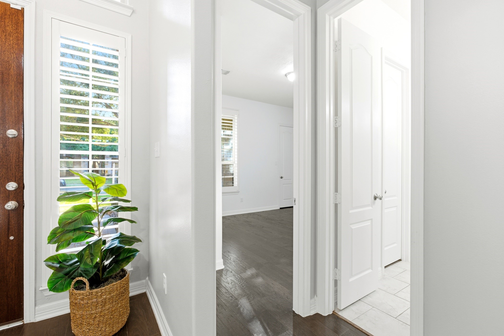 27834 Hunters Rock Lane Katy, TX 77494 - Photo 10 of 46 a view of a hallway with wooden floor and a potted plant