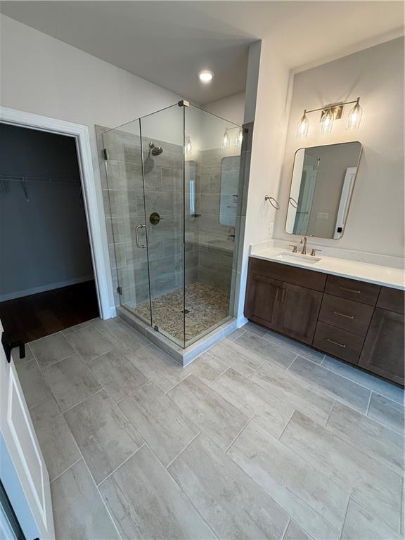 419 Duncan Dene Drive, Unit 140 Alpharetta, GA 30022 - Photo 16 of 22 a bathroom with a sink a mirror and a shower