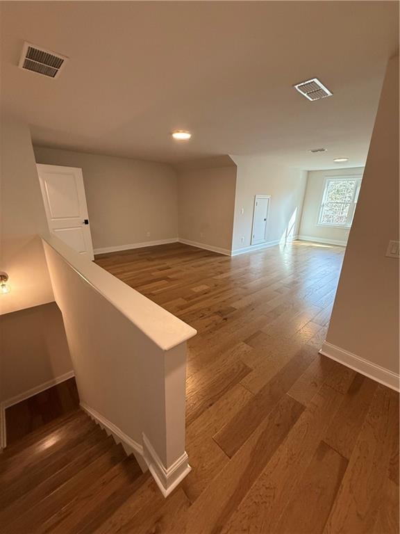 419 Duncan Dene Drive, Unit 140 Alpharetta, GA 30022 - Photo 19 of 22 a view of an empty room with wooden floor and a window