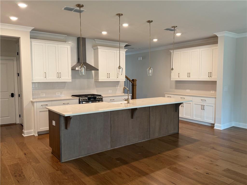 419 Duncan Dene Drive, Unit 140 Alpharetta, GA 30022 - Photo 3 of 22 a kitchen with stainless steel appliances granite countertop a sink a stove and a refrigerator