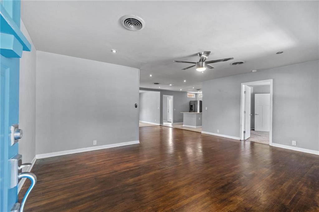 2105 Fortview Road Austin, TX 78704 - Photo 4 of 37 Hardwood flooring extends throughout this expansive living space, offering a refined entrance to the home.