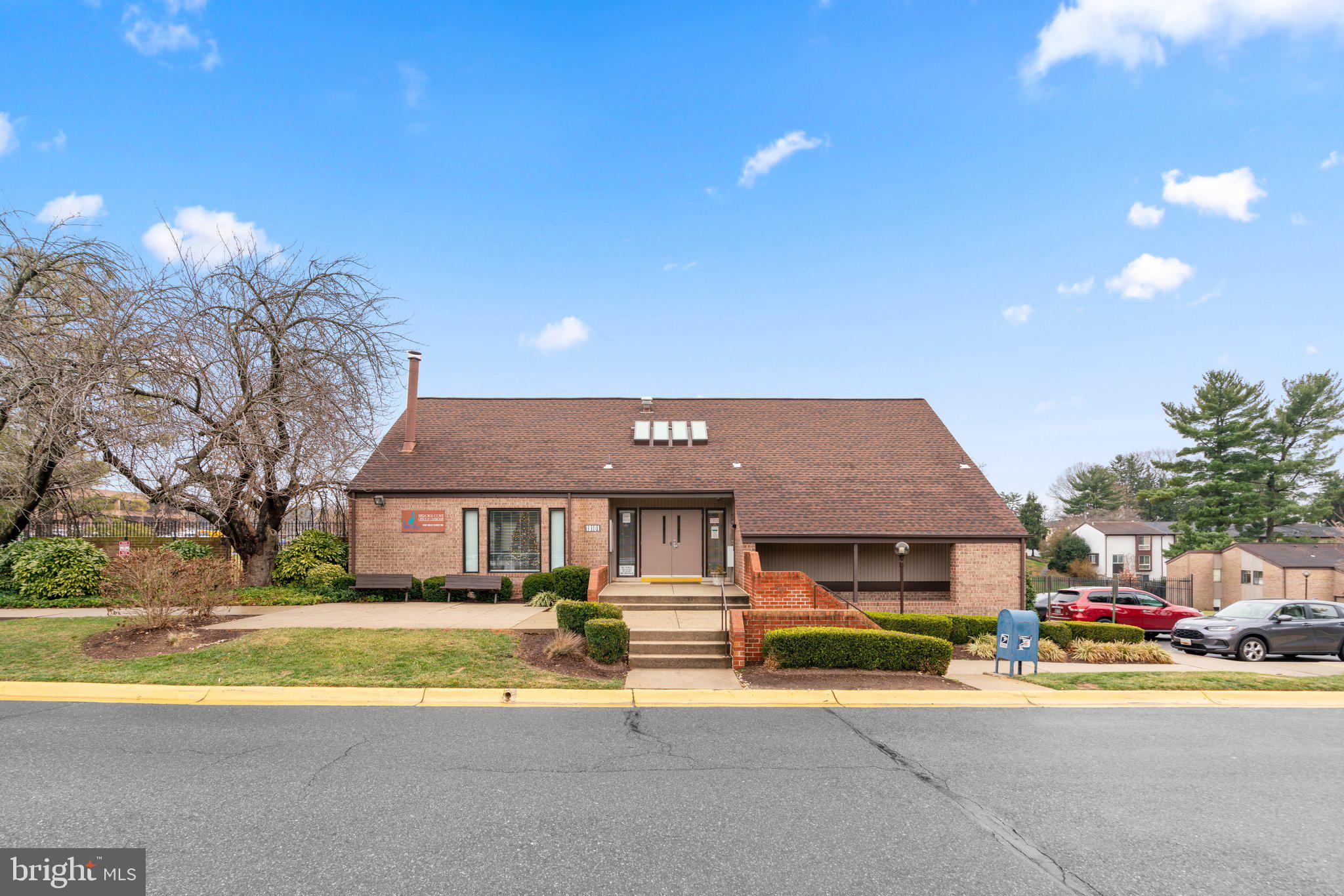 19048 Mills Choice Road, Unit 19048 Gaithersburg, MD 20886 - Photo 35 of 40 a front view of a house with a big yard and large tree