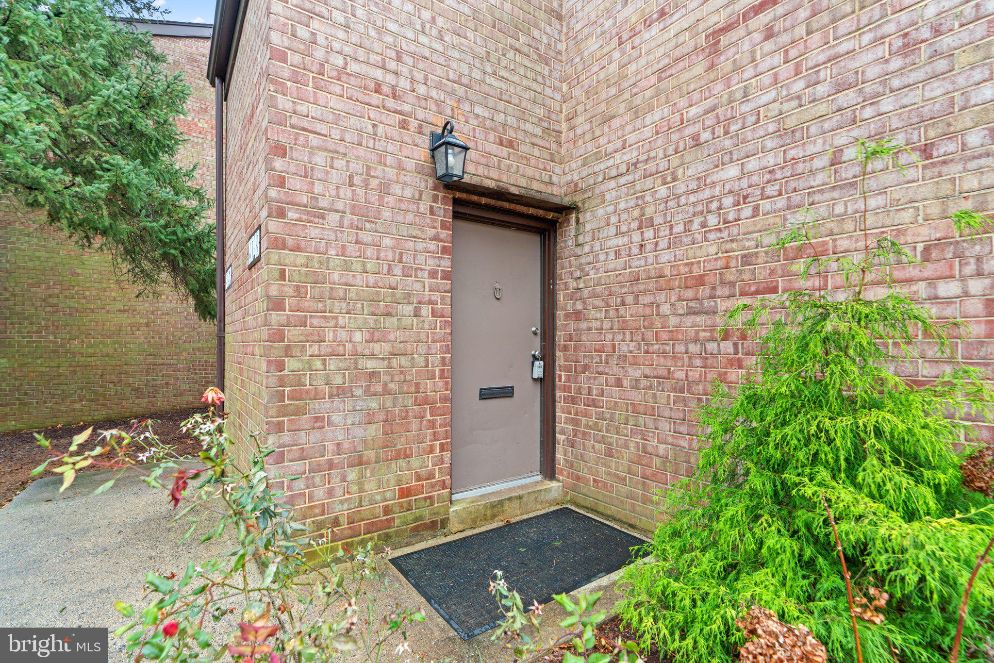 19048 Mills Choice Road, Unit 19048 Gaithersburg, MD 20886 - Photo 4 of 40 front view of a brick house with a yard