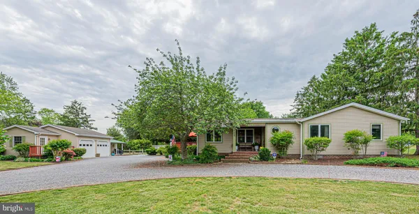 a front view of house with yard and outdoor seating
