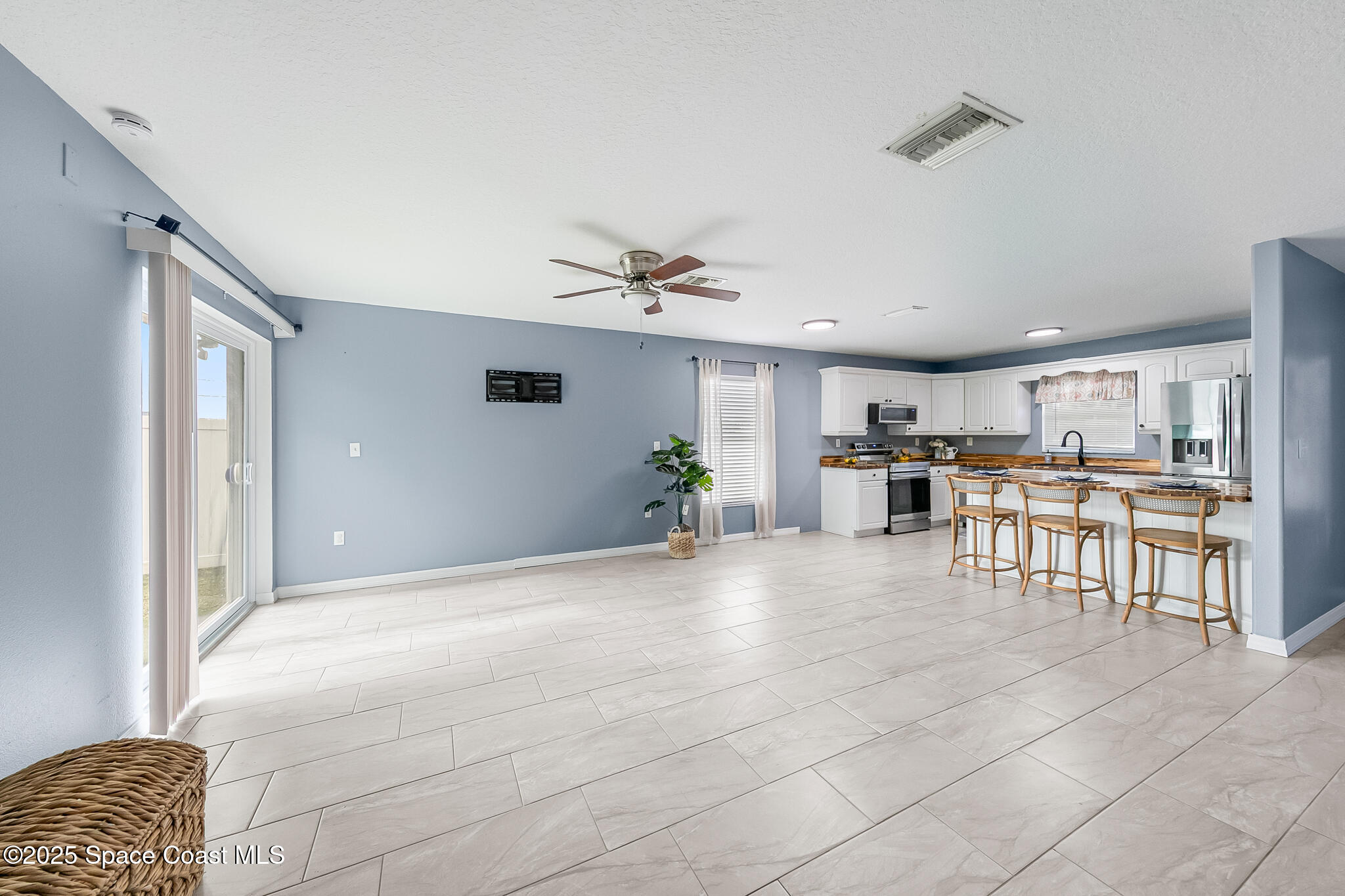 233 Broadview Drive Cocoa, FL 32922 - Photo 15 of 44 a view of a livingroom with furniture and a ceiling fan