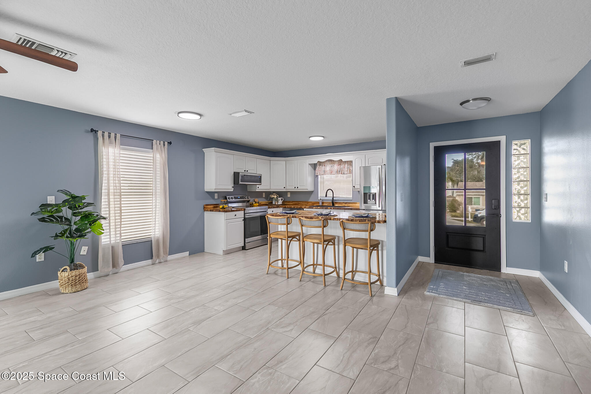 233 Broadview Drive Cocoa, FL 32922 - Photo 18 of 44 a view of kitchen with furniture and refrigerator