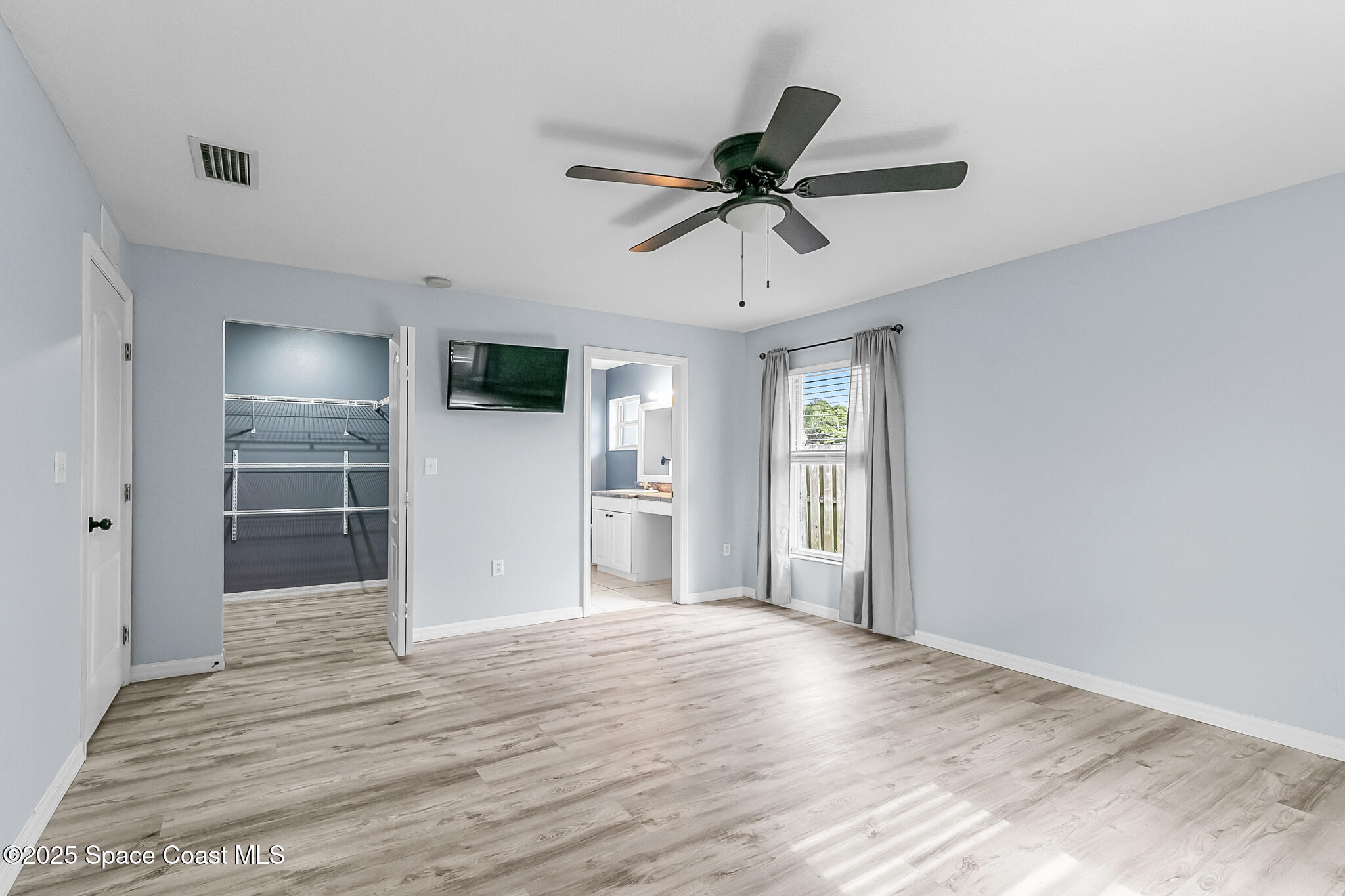 233 Broadview Drive Cocoa, FL 32922 - Photo 20 of 44 a view of empty room with wooden floor and window
