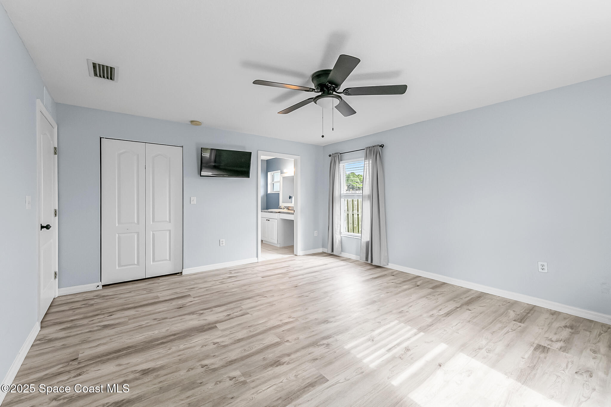 233 Broadview Drive Cocoa, FL 32922 - Photo 21 of 44 a view of empty room with wooden floor and ceiling fan