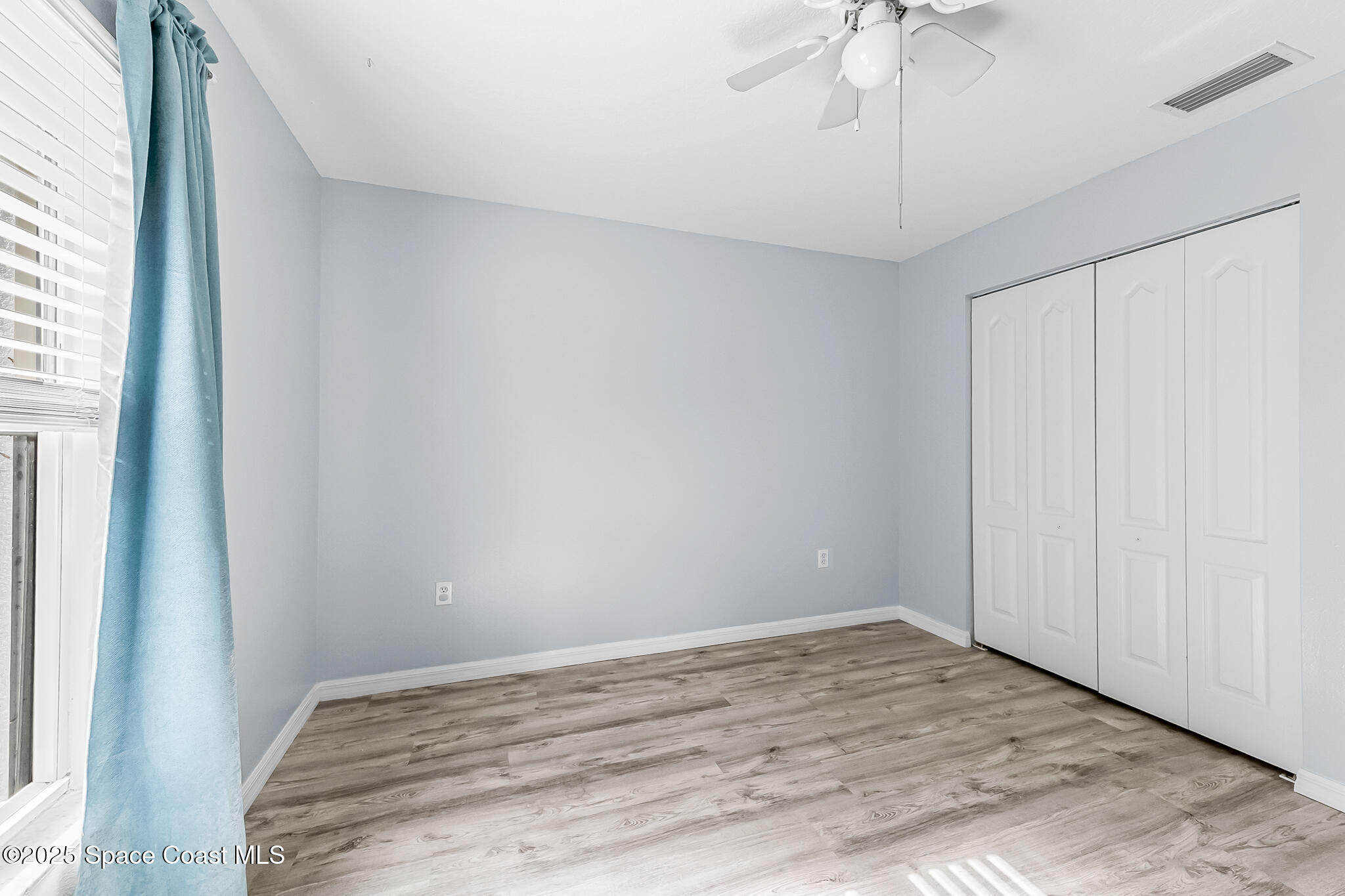 233 Broadview Drive Cocoa, FL 32922 - Photo 25 of 44 a view of empty room with wooden floor and fan