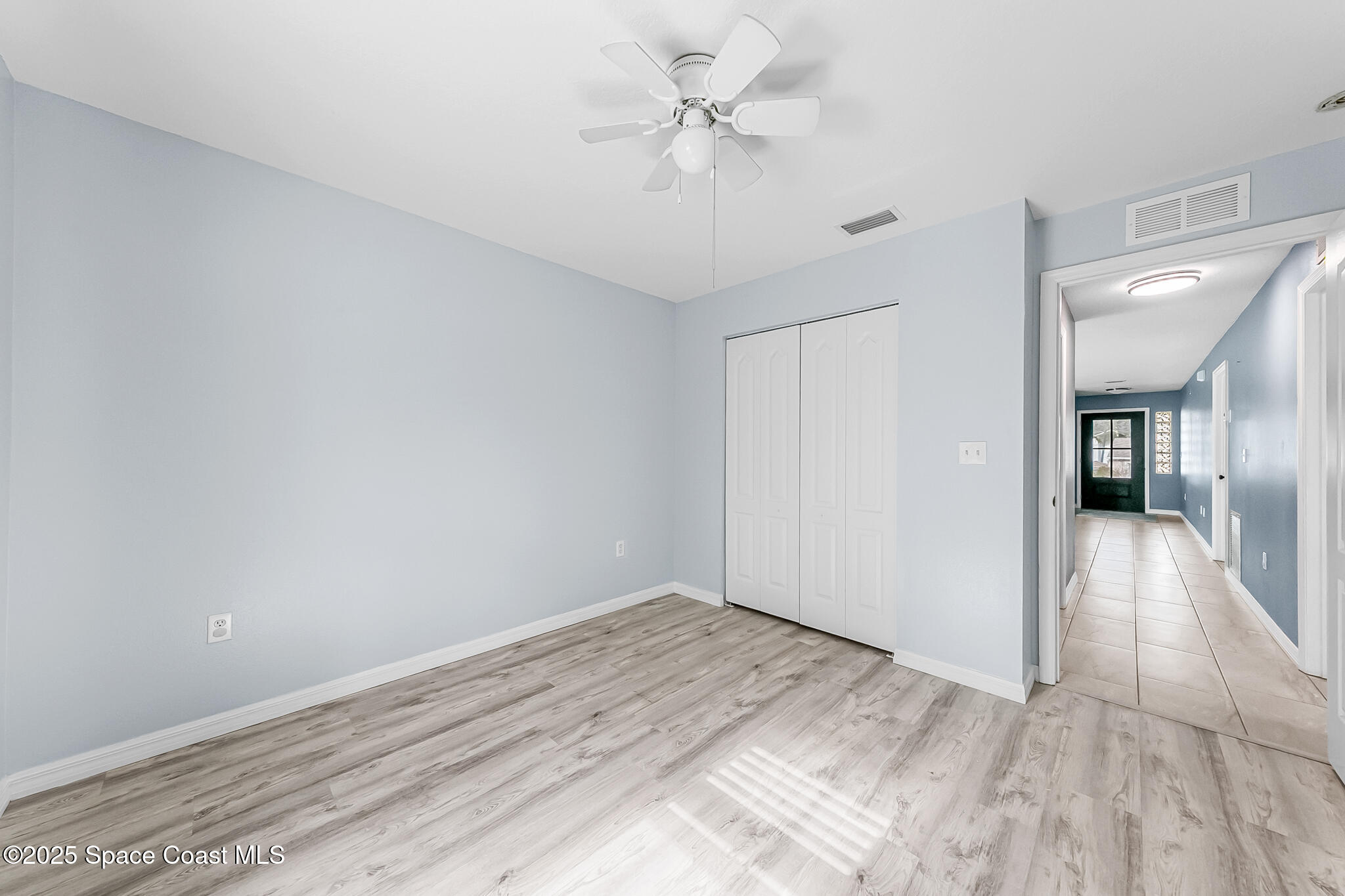 233 Broadview Drive Cocoa, FL 32922 - Photo 26 of 44 wooden floor in an empty room with a window