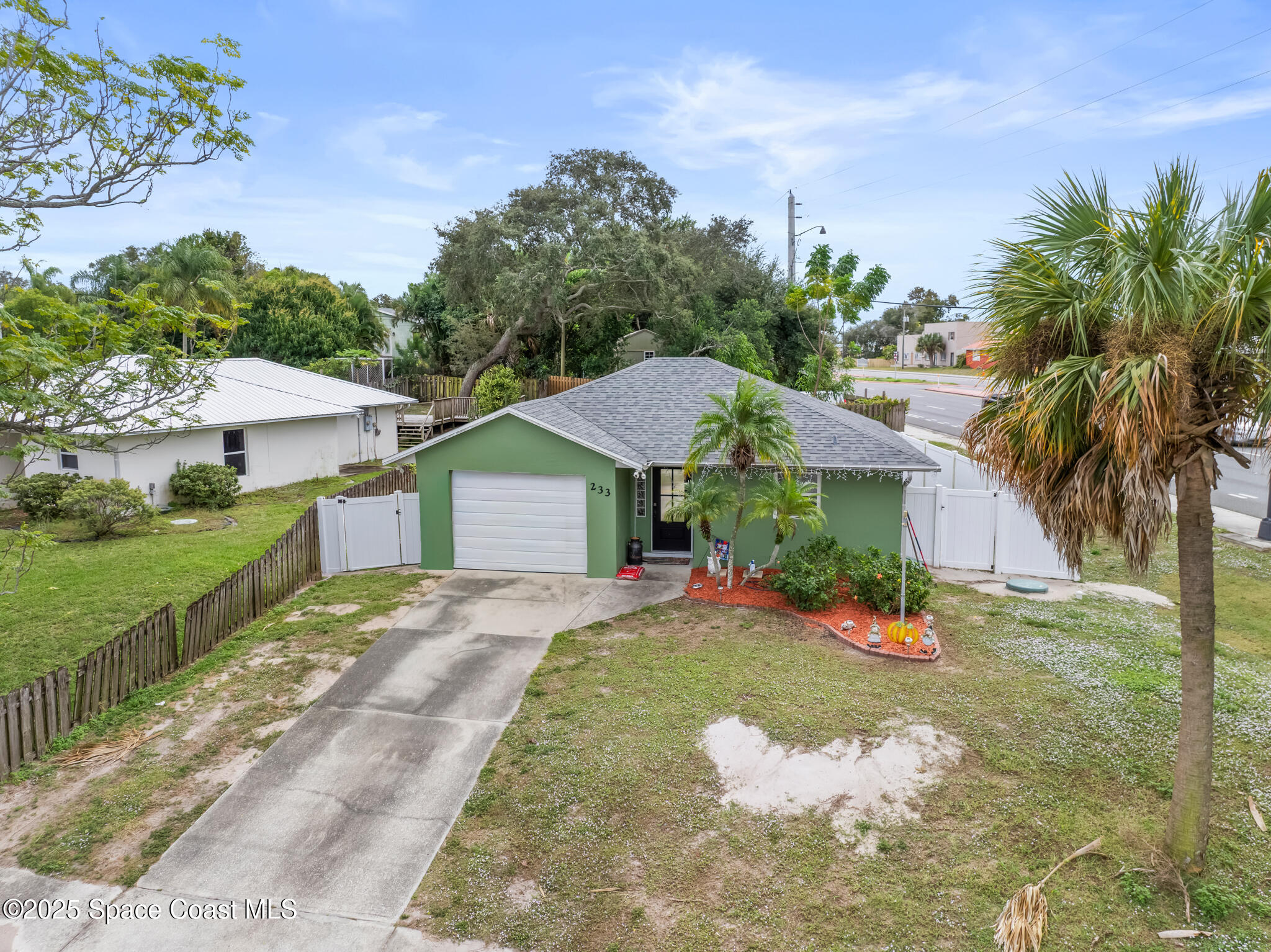 233 Broadview Drive Cocoa, FL 32922 - Photo 4 of 16 a front view of a house with a yard and potted plants