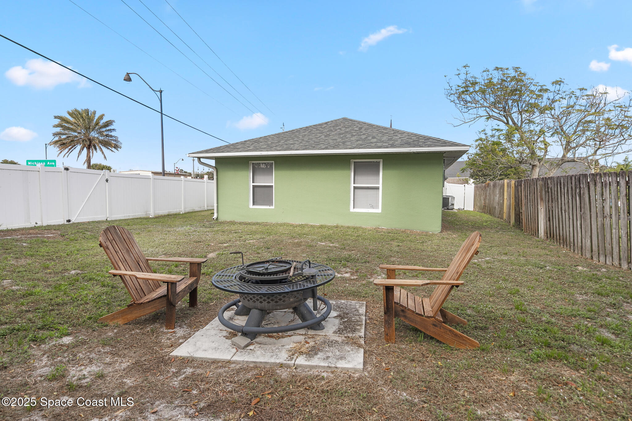 233 Broadview Drive Cocoa, FL 32922 - Photo 42 of 44 a view of a backyard with table and chairs and wooden fence