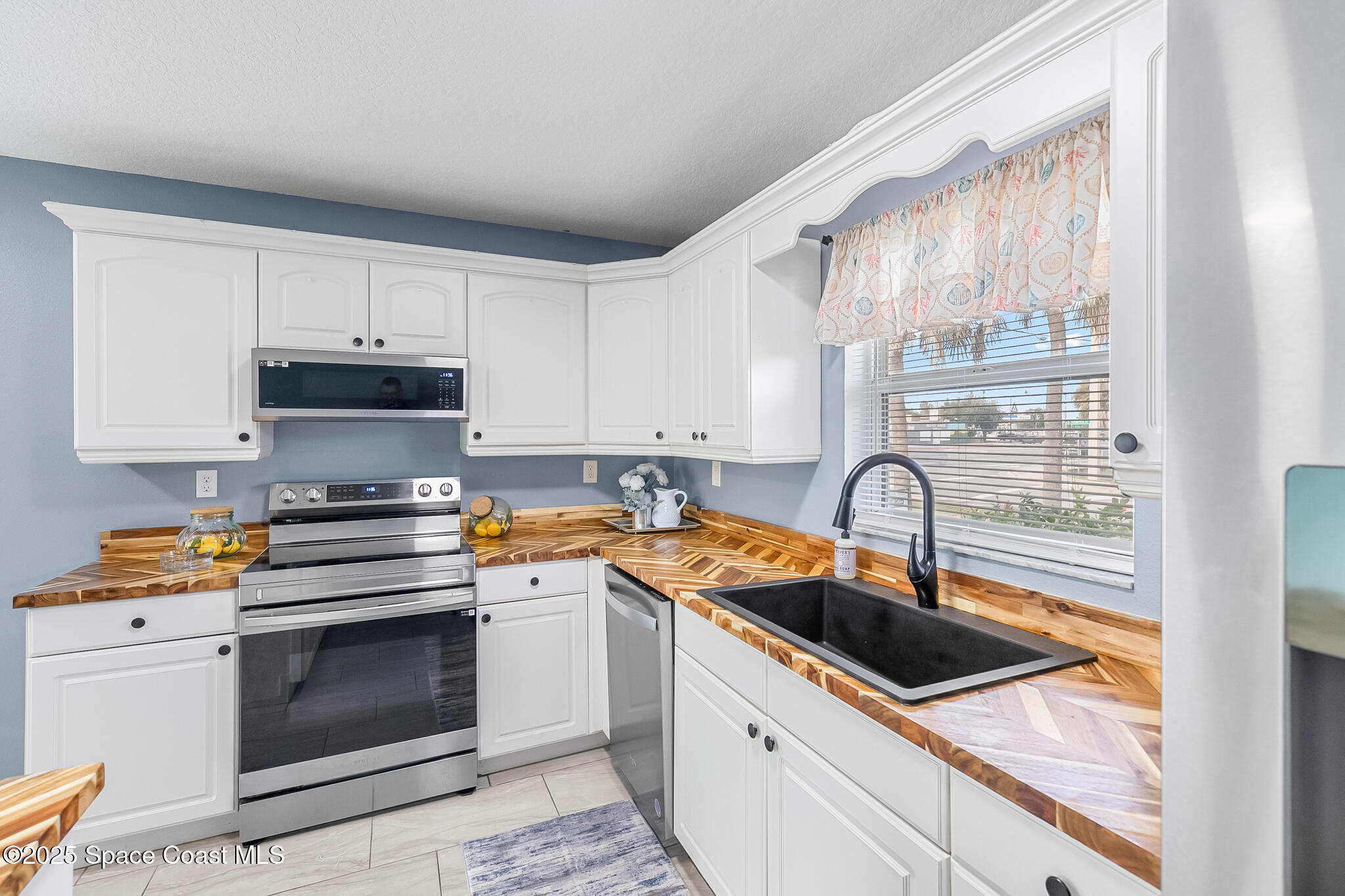 233 Broadview Drive Cocoa, FL 32922 - Photo 8 of 44 a kitchen with granite countertop a sink stainless steel appliances and cabinets