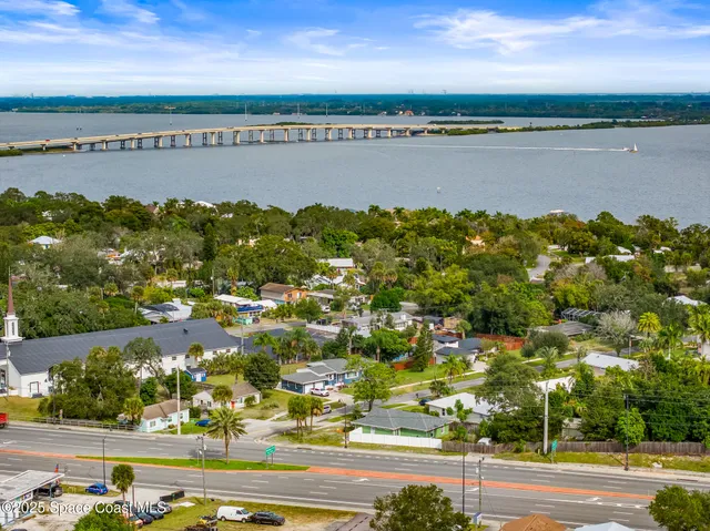 an aerial view of lake and houses with outdoor space