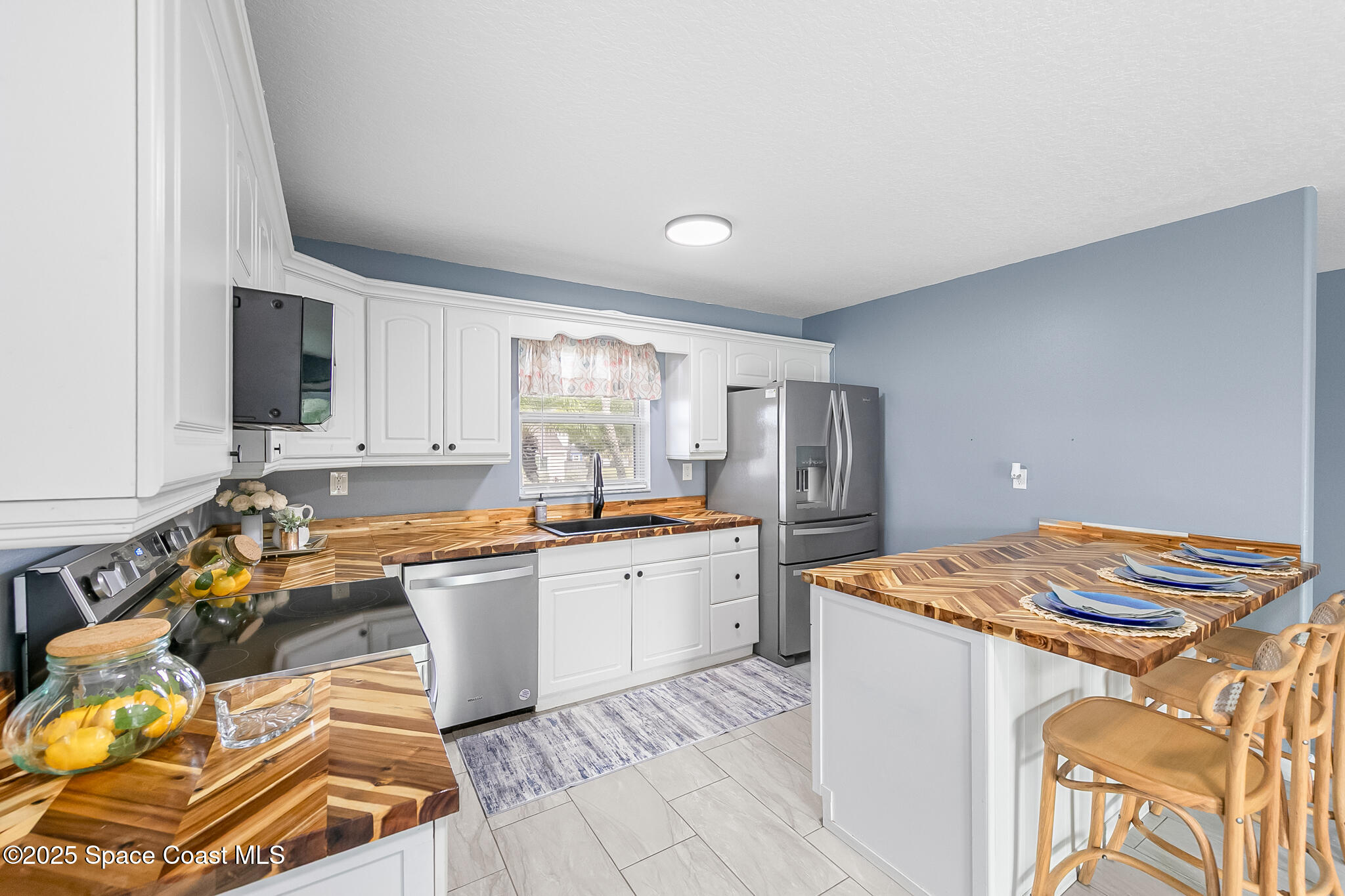 233 Broadview Drive Cocoa, FL 32922 - Photo 10 of 44 a kitchen with a sink stove and refrigerator