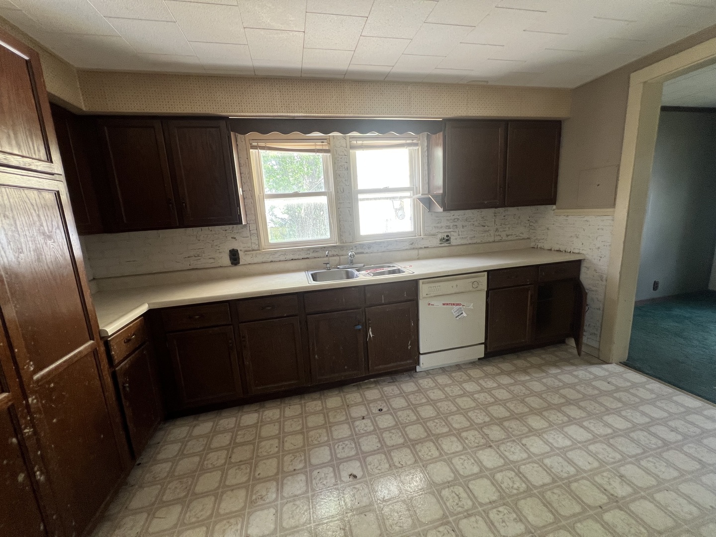 529 North 2nd Street Watseka, IL 60970 - Photo 5 of 16 a kitchen with a sink a stove and a refrigerator