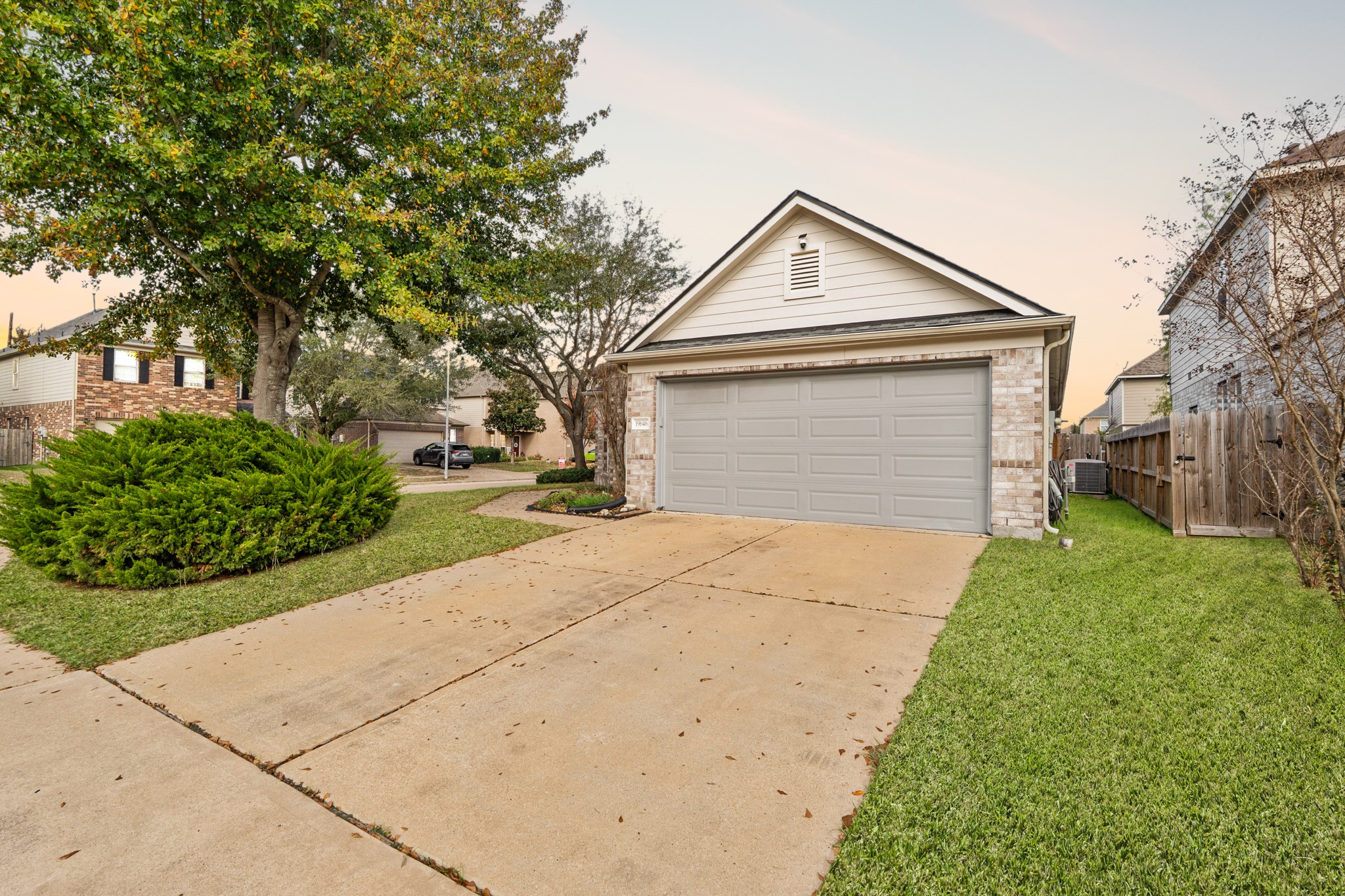 19646 Hardwood Ridge Trail Cypress, TX 77429 - Photo 2 of 22 The attached two-car garage offers convenient parking and storage, while neatly edged landscaping and shrubs line the walkway and foundation.