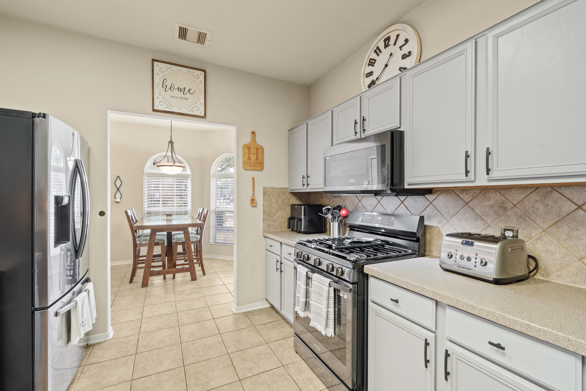 19646 Hardwood Ridge Trail Cypress, TX 77429 - Photo 9 of 22 The kitchen opens directly into a casual dining area, visible through a wide entryway, making the space ideal for both everyday living and entertaining.