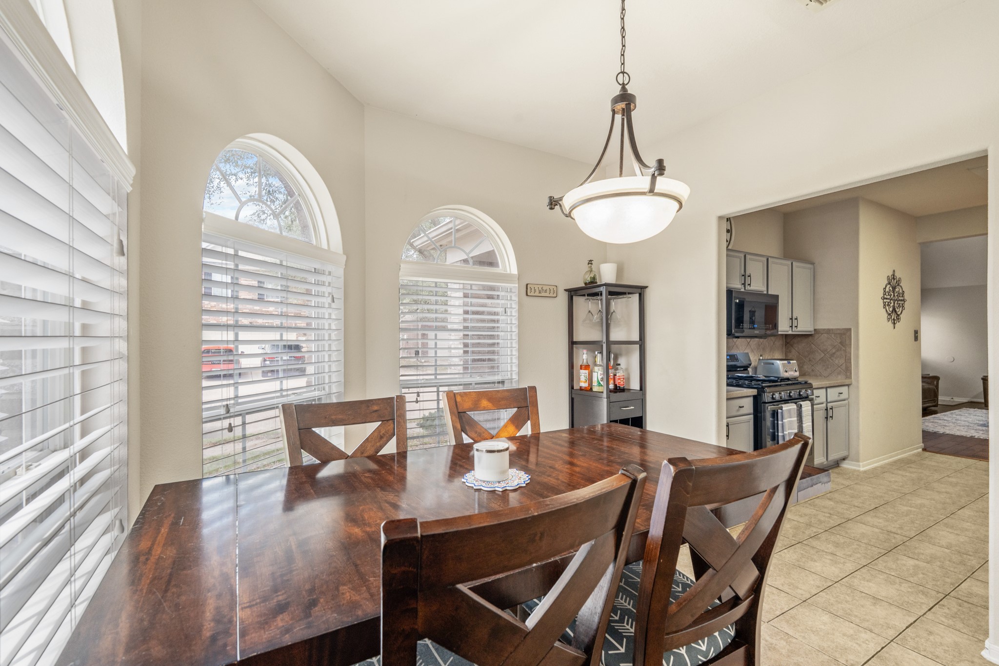 19646 Hardwood Ridge Trail Cypress, TX 77429 - Photo 10 of 22 The space features neutral tile flooring that flows seamlessly through the kitchen and into the adjoining dining area, enhancing the home’s open layout.