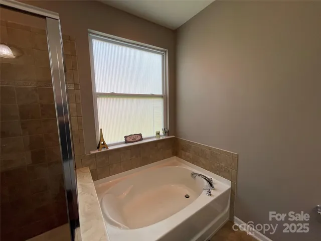a bathroom with a tub and shower