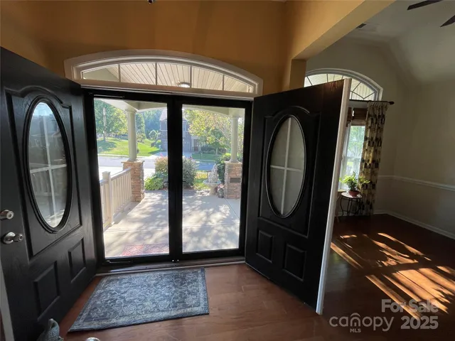 a view of a entryway door with wooden floor