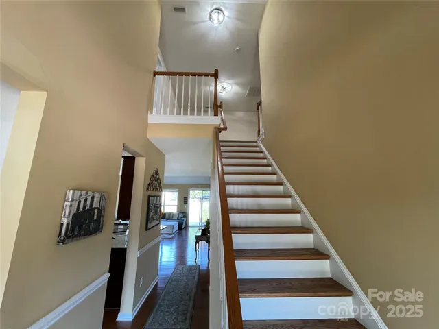 a view of entryway and hall with wooden floor