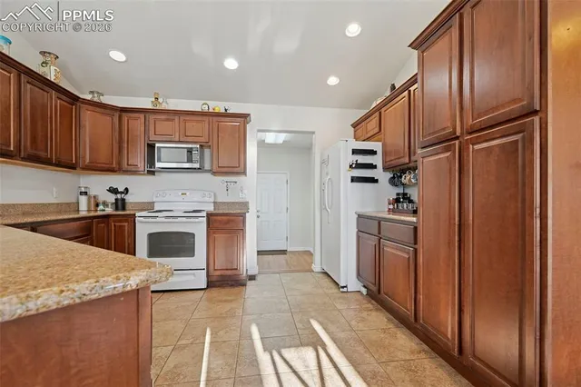 a kitchen with stainless steel appliances granite countertop a refrigerator sink and cabinets