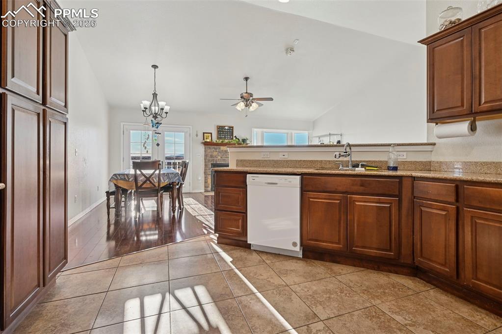 16575 Cathys Loop Peyton, CO 80831 - Photo 14 of 49 a kitchen with cabinets and chairs