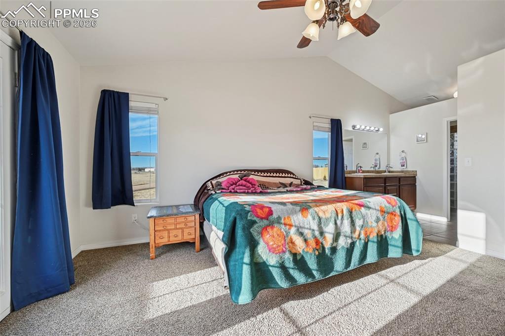 16575 Cathys Loop Peyton, CO 80831 - Photo 15 of 49 a bedroom with a bed and a chandelier