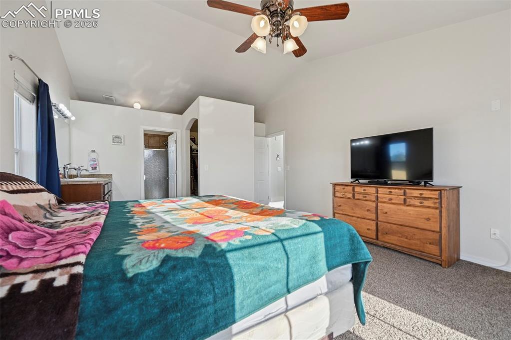 16575 Cathys Loop Peyton, CO 80831 - Photo 16 of 49 a bedroom with a bed and a flat screen tv