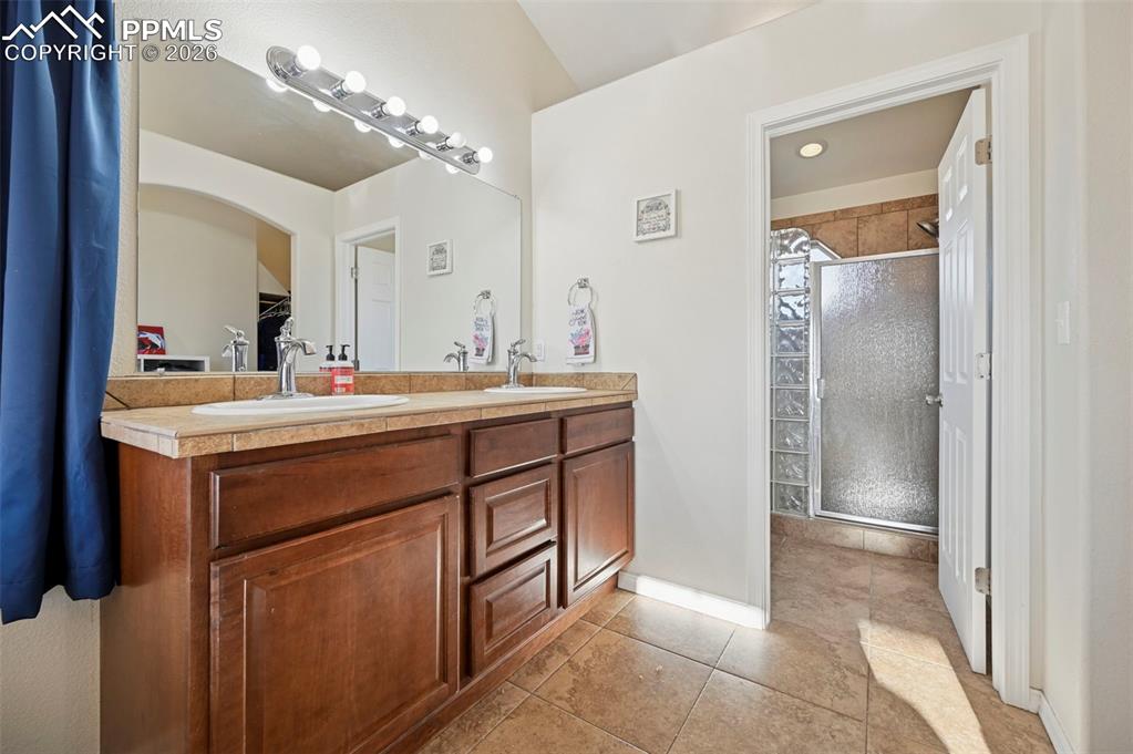 16575 Cathys Loop Peyton, CO 80831 - Photo 18 of 49 a bathroom with a sink vanity and a mirror
