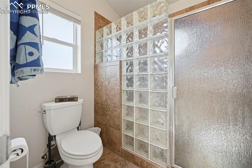 16575 Cathys Loop Peyton, CO 80831 - Photo 19 of 49 a white toilet sitting next to a shower curtain