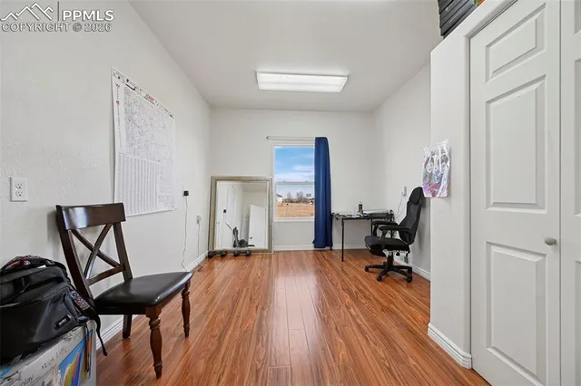 a view of a workspace with furniture and a window