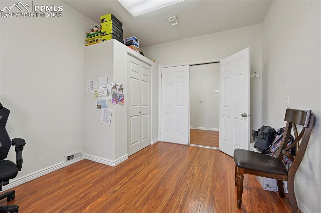 16575 Cathys Loop Peyton, CO 80831 - Photo 24 of 49 a view of a workspace with furniture and wooden floor