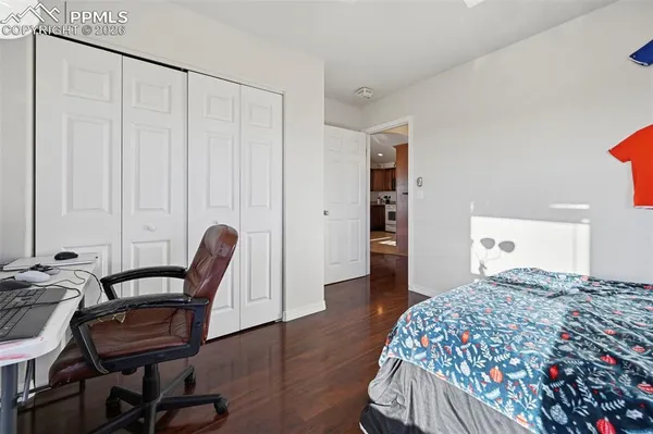 a bedroom with a bed and a chair