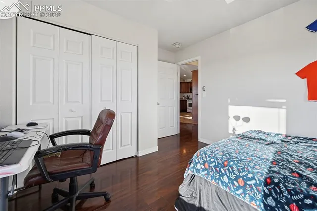 a bedroom with a bed and a chair