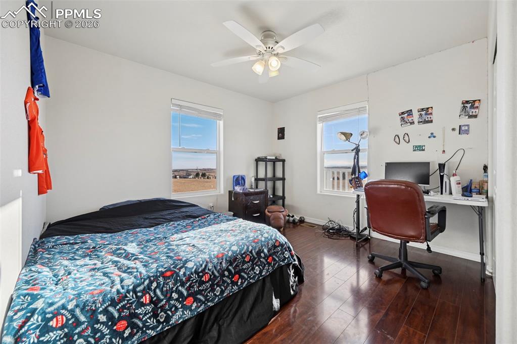 16575 Cathys Loop Peyton, CO 80831 - Photo 26 of 49 a bedroom that has a bed and a chair in it