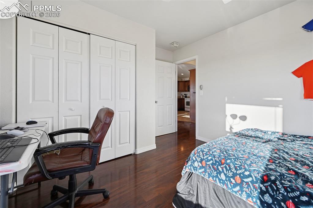 16575 Cathys Loop Peyton, CO 80831 - Photo 26 of 49 a bedroom with a bed and a chair