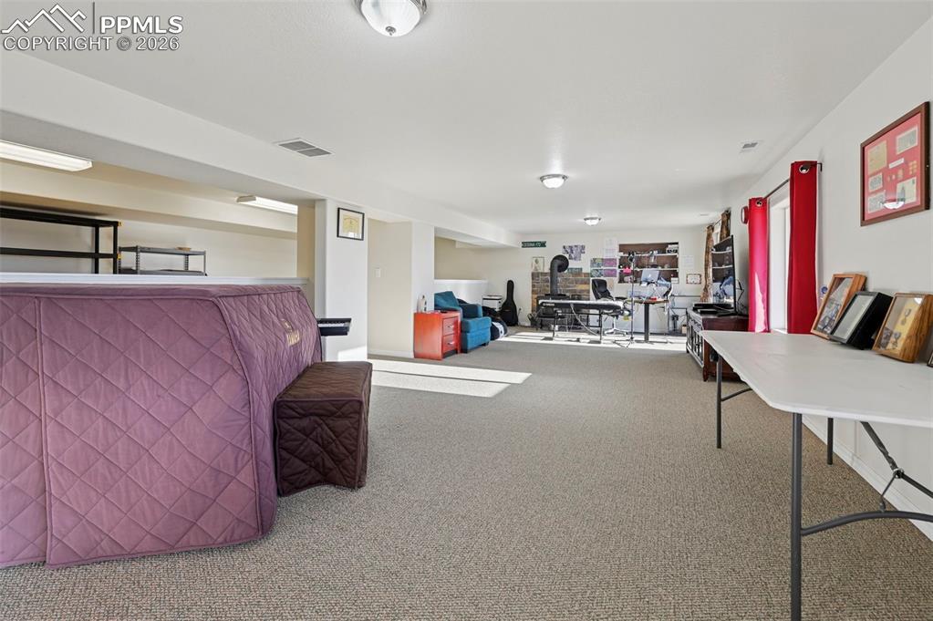 16575 Cathys Loop Peyton, CO 80831 - Photo 33 of 49 a living room with furniture and a flat screen tv