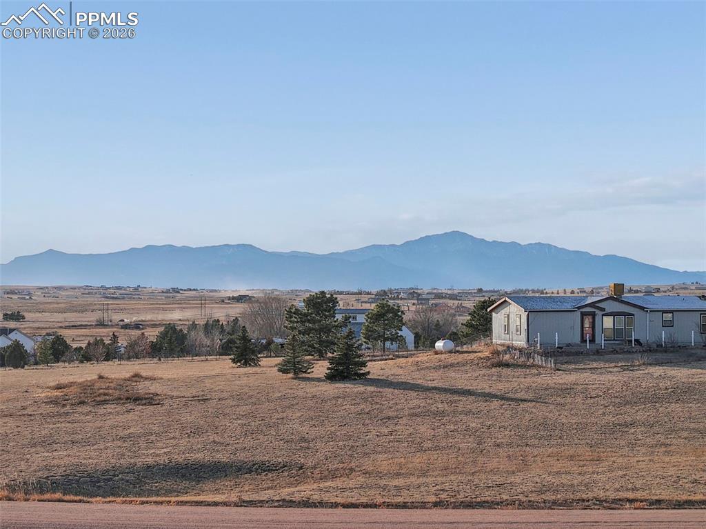 16575 Cathys Loop Peyton, CO 80831 - Photo 41 of 49 a view of house with a yard
