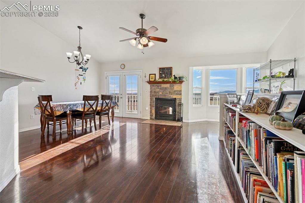 16575 Cathys Loop Peyton, CO 80831 - Photo 7 of 49 a living room with fireplace furniture and a book shelf
